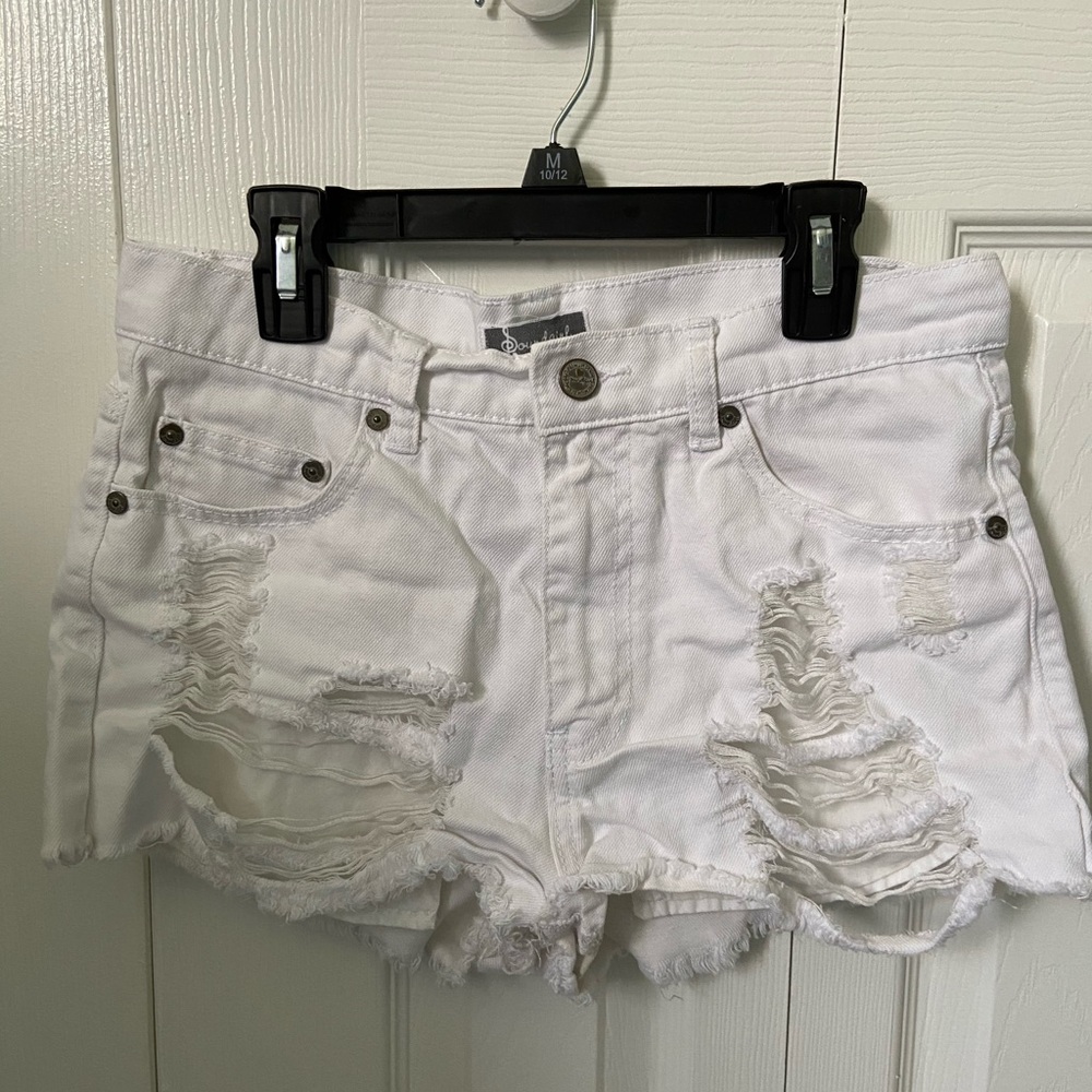 White ripped shorts